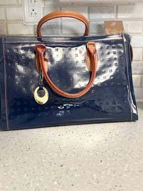 NWOT Arcadia Navy Patent Handbag with Tan Trim and Gold Charm.